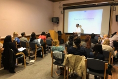 Faiz delivering a lecture in Telephone triage and remote consultation